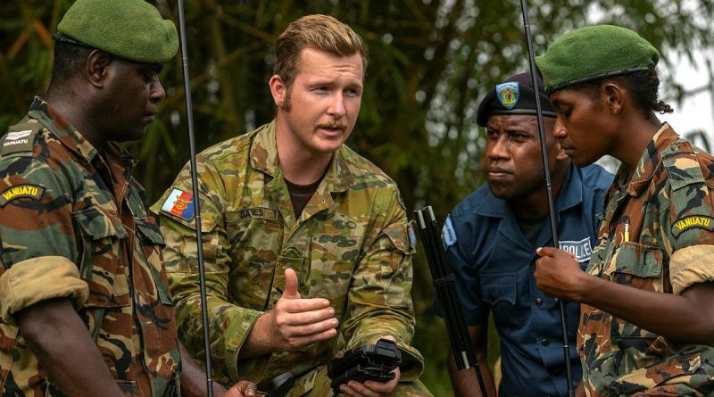 Lance Corporal Ryan Davies speaks with Vanuatu Police Force members Corporal Alex Sope, left, Constable Simeon Samuel and Private Georgette Kalorib during training with the Barrett 4090 High Frequency Man-Pack Radio. Story by Captain Taylor Lynch. Photo by Corporal Kieren Whiteley.