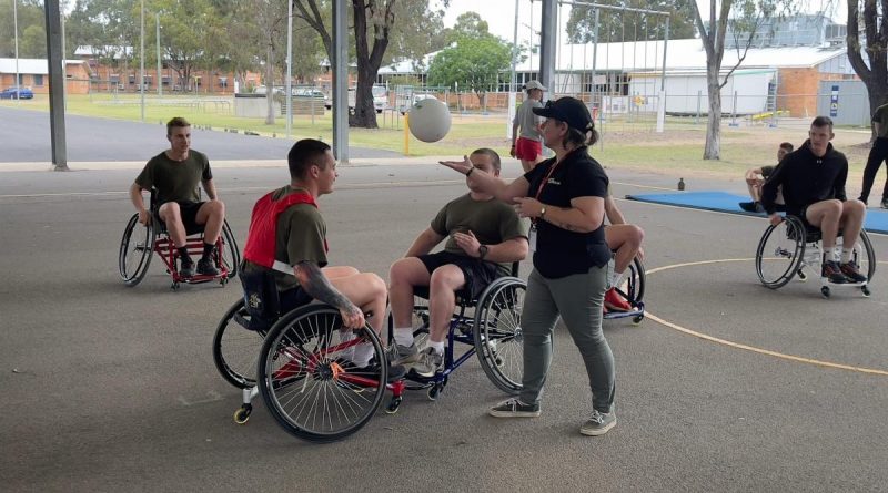 Veteran engagement specialist from Invictus Australia, Rachael Kerrigan, umpires a wheelchair basketball game with soldiers from the School of Infantry at an adaptive sport demonstration event at Singleton, NSW. Story by Major Carrie Robards.