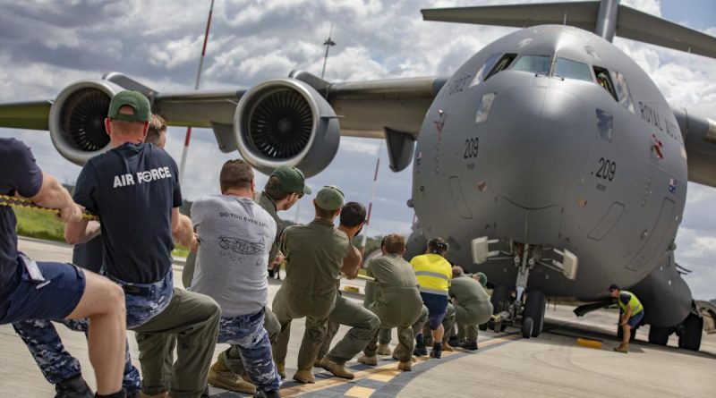 No. 36 Squadron aviators pull a C-17A Globemaster III aircraft during the tug-o-war challenge at RAAF Base Amberley. Story by Flying Officer Lily Lancaster. Photo by Corporal Jesse Kane.