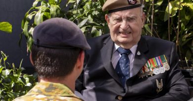 Australian Army soldier Corporal A, from the 1st Commando Regiment, talks with Second World War British Army veteran Mr John Morris in the garden of his home in Merrylands, Sydney. Photo by Chief Petty Officer Cameron Martin.