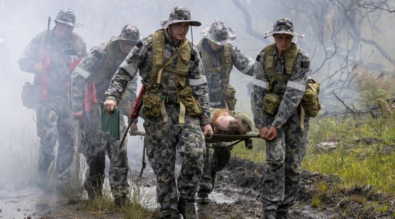 (Left) Royal Australian Naval College New Entry Officers' Course 65 Midshipman Stuart Munro and Midshipman Ellen Kozlowska carry the front of a stretcher after rescuing an unconscious pilot during a training scenario for Exercise Matapan at HMAS Creswell. Story by Private Jacob Joseph.