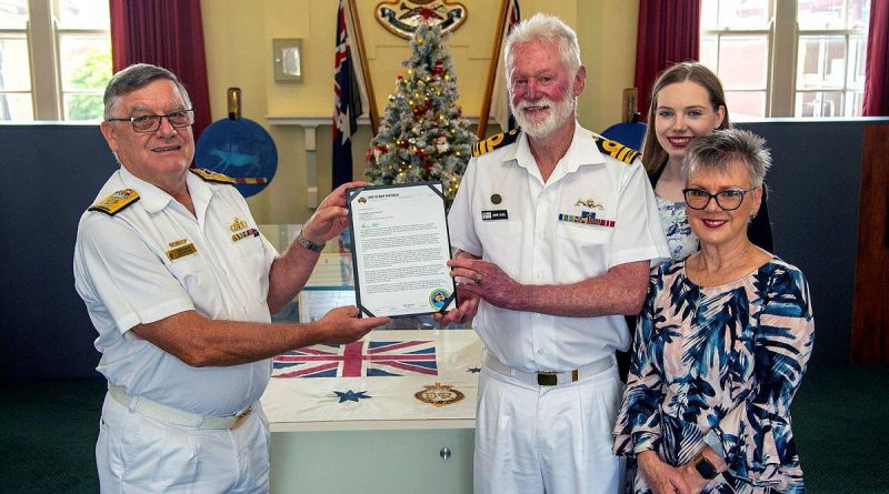 Commodore Greg Yorke Senior Naval Officer Victoria, presents a farewell letter on behalf of Chief of Navy to Commander John Goss, in company with his wife, Commander Janine March-Goss, and their daughter Ebony at HMAS Creswell. Story by Lieutenant Ben Willee. Photo by POIS James Whittle..