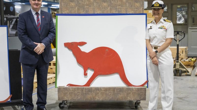 (Australian War Memorial Director Mr Matt Anderson and Captain Anita Nemarich, RAN, with one of the donated red kangaroo funnel insignia from HMAS Parramatta at the Treloar Technology Centre, ACT. Story and photo by Leading Seaman Kylie Jagiello.