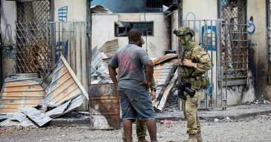 Australian Army Corporal Brodie Cross from Joint Task Group 637.3 talks with a local man in Honiara, Solomon Islands, on 02 December 2021. Photo by Corporal Brandon Grey.