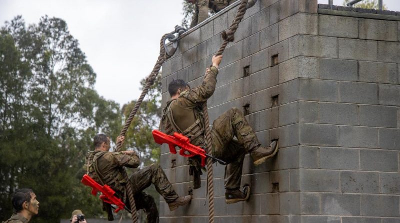 Privates Meaham Bailey, left, and Bagu Tancredi climb the rope wall as part of Exercise Hardcorps at the School of Infantry, Singleton, New South Wales. Story by Captain Catalina Martinez Pinto. Photo by Corporal Shane Kelly.