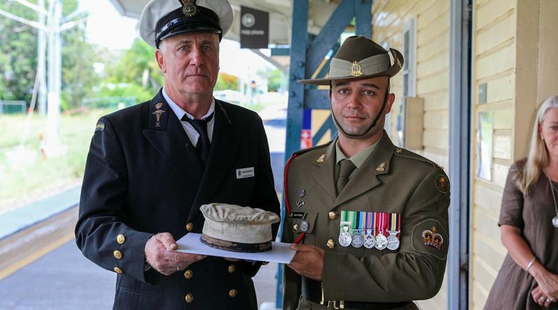 Former Navy paramedic Jamie Hodgess, left, and his nephew Army petroleum operator Warrant Officer Class Two Stuart Hodgess with the Navy hat that belonged to Jamie Hodgess' father, Gus. Story by Captain Thomas Kaye . Photo by Lance Corporal Christopher Smith.