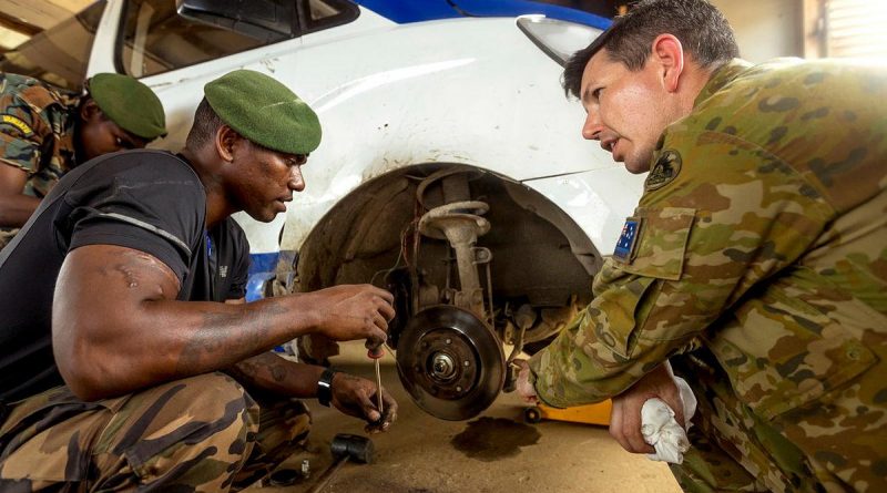 Australian Army Sergeant Dale Daff and Vanuatu Police Force Private John Pierre work on a vehicle during the vehicle maintainers' course at Cook Barracks in Port Vila, Vanuatu. Story by Captain Taylor Lynch. Photo by Corporal Robert Whitmore.