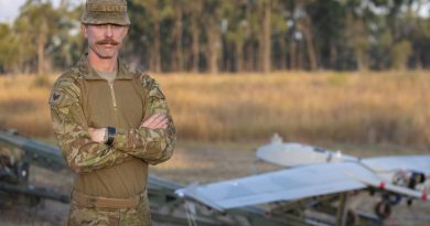 Sergeant Marc Plant stands in front of a Shadow 200 UAS. Photo by Petty Officer Lee-Anne Cooper.