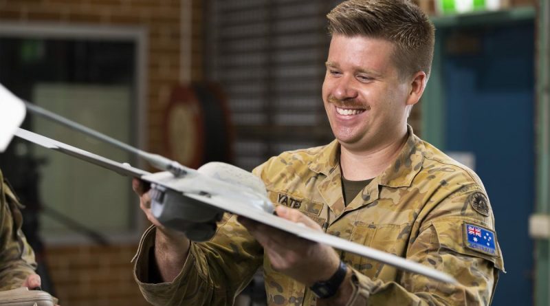 Bombadier Mitchell Yates looks at a Wasp AE Small UAS at the Army Reserve Kogarah Depot in Sydney. Story by Captain Mark Beretta. Photo by Corporal Dustin Anderson.