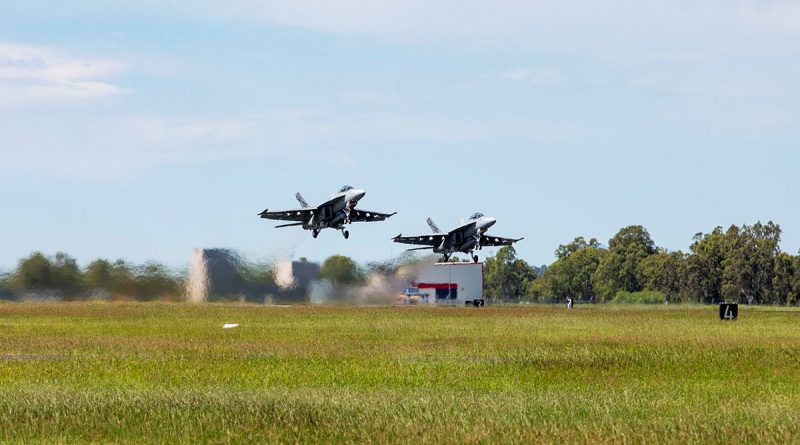 Two F/A-18F Super Hornets from No. 1 Squadron A44-211 (left) and A44-218, depart RAAF Base Amberley. Story by Flying Officer Robert Hodgson. Photo by Leading Aircraftwoman Emma Schwenke.