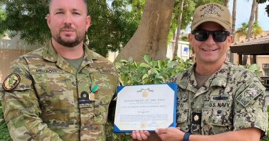 Lieutenant Justin Mellross, left, receives the United States Navy and Marine Corps Achievement Medal from Commanding Officer USS Firebolt Lieutenant Commander Raymond Miller IV. Photo: by Lieutenant E Garcia, United States Navy.