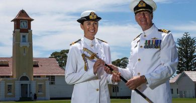 Commander Nick Barker passes on his father's ceremonial sword to his daughter, Lieutenant Emma Barker, following her graduation from New Entry Officers' Course at HMAS Creswell. Story by Leading Seaman Kylie Jagiello. Photo by Leading Seaman David Cox.