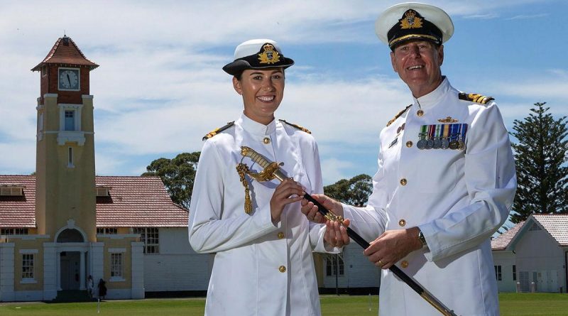 Commander Nick Barker passes on his father's ceremonial sword to his daughter, Lieutenant Emma Barker, following her graduation from New Entry Officers' Course at HMAS Creswell. Story by Leading Seaman Kylie Jagiello. Photo by Leading Seaman David Cox.