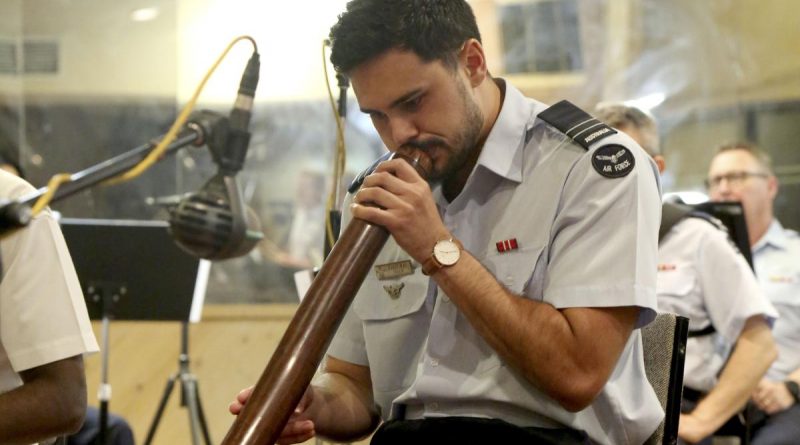 Air Force officer Flight Lieutenant Tjapukai Shaw plays the didgeridoo during the new Australian national anthem recording at Alan Eaton Studios in Melbourne, Victoria. Story by Leading Seaman Kylie Jagiello. Photo by Petty Officer Nina Fogliani.