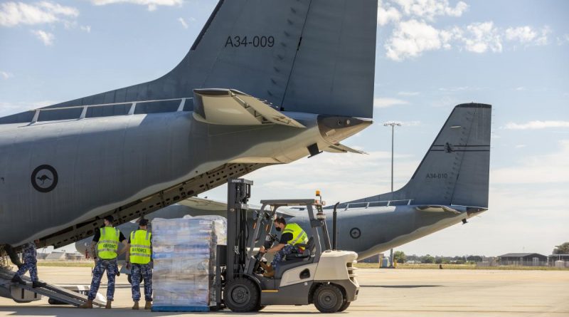 Air Force Aviators load supplies onto a C-27J Spartan aircraft tasked to fly to isolated Coober Pedy, South Australia. Photo by Leading Aircraftman Stewart Gould.