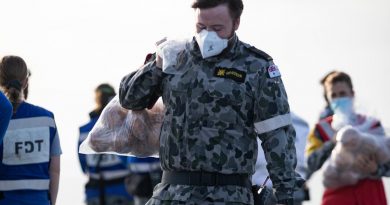 Navy sailor Seaman combat systems operator Mark Duivesteyn carries fruit gifted from the Tonga onboard HMAS Adelaide during Operation Tonga Assist 2022. Story by Lieutenant Brendan Trembath. Photo by Leading Seaman David Cox.