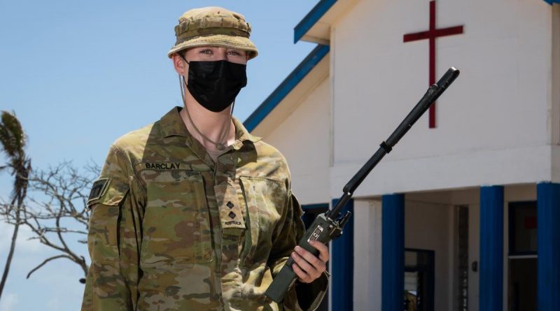 Lieutenant Lauren Barclay outside the Wesleyan church on Atata Island, Tonga. Story by Captain Zoe Griffyn. Photo by Leading Seaman David Cox.