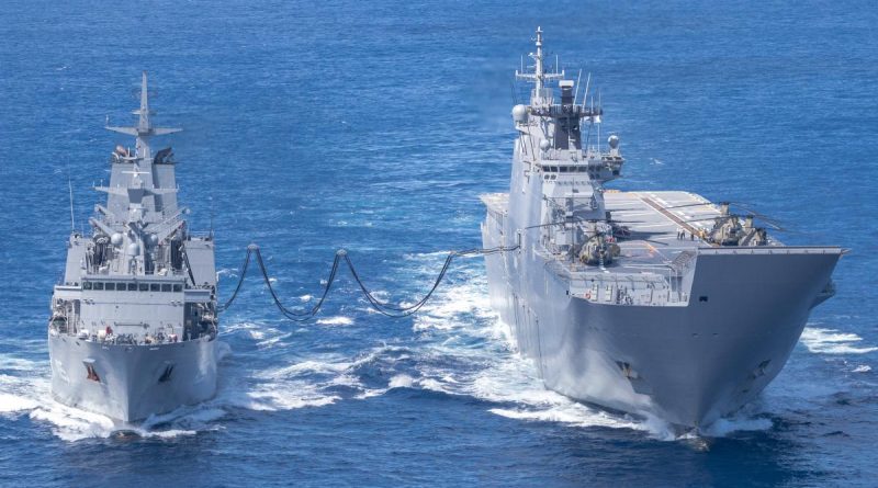 HMAS Supply (left) and HMAS Adelaide conduct a replenishment at sea during Operation Tonga Assist 2022. Story by Captain Zoe Griffyn. Photo by Corporal Robert Whitmore.