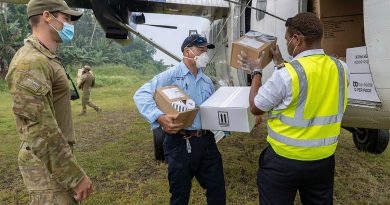 A RAAF combat controller from No. 4 Squadron and Mr Rob Crowell (centre) from the Australian Medical Assistance Team help unload Australian Government critical aid supplies from a Solomon Airlines DHC-6 Twin Otter aircraft at Auki airport, Solomon Islands. Story by Captain Peter March. Photo by Corporal Jarrod McAneney.