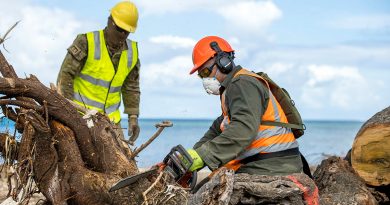 Republic of Fiji Military Forces engineer Sapper Saimoni Kamikamica (right) and Australian Army soldier Lance Corporal Kobie Rogers work together to clear a fallen tree on Atata Island during Operation Tonga Assist 2022. Story by Lieutenant Brendan Trembath. Photo by Corporal Robert Whitmore.