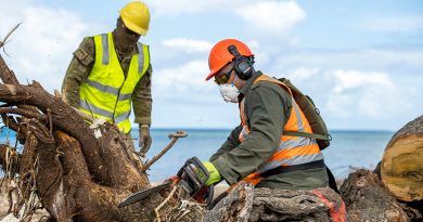 Republic of Fiji Military Forces engineer Sapper Saimoni Kamikamica (right) and Australian Army soldier Lance Corporal Kobie Rogers work together to clear a fallen tree on Atata Island during Operation Tonga Assist 2022. Story by Lieutenant Brendan Trembath. Photo by Corporal Robert Whitmore.