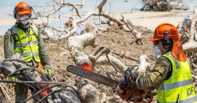 Lance Corporal Kobie Rogers from 2nd Combat Engineer Regiment cuts a fallen tree on Atata Island, Tonga, during Operation Tonga Assist 2022. Story by Lieutenant Brendan Trembath. Photo by Corporal Robert Whitmore.