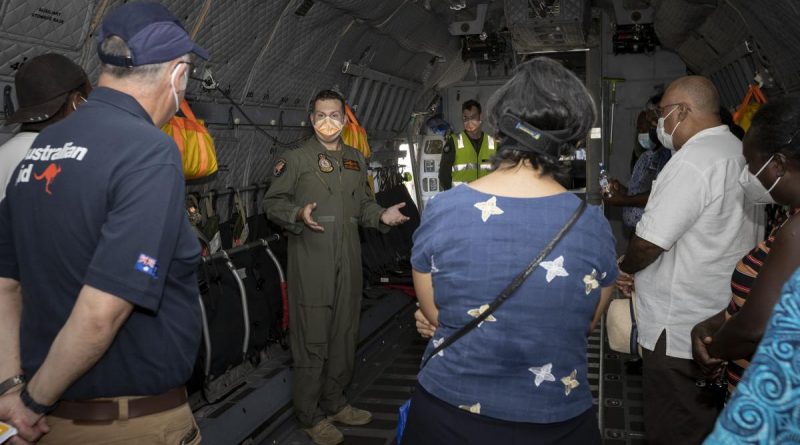 RAAF pilot Squadron Leader Justin Della Bosca gives Solomon Islands Government officials a tour inside a C-27J Spartan aircraft at Honiara international airport, Solomon Islands. Story by Captain Peter March. Photo by Corporal Jarrod McAneney.