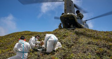 An Army CH-47F Chinook helicopter lands on Kao Island, allowing three Tongan technicians to unload equipment to repair telecommunications equipment. Story by Lieutenant Brendan Trembath. Photo by Petty Officer Christopher Szumlanski..