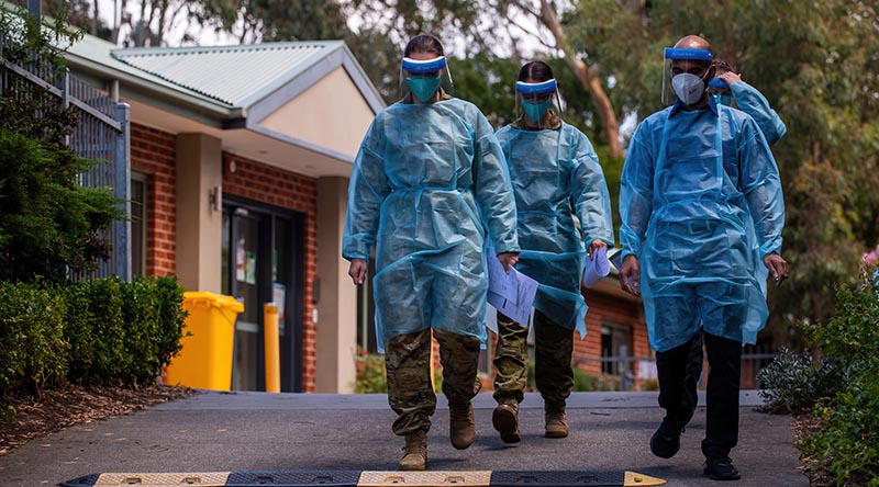 Australian Army Captain Amelia Thompson and Corporal Jade Hipkiss-Winder, Mr Roji Kurian and Royal Australian Navy Able Seaman Emily McNeill at an aged-care facility in Frankston in Victoria. Photo by Private Michael Currie.