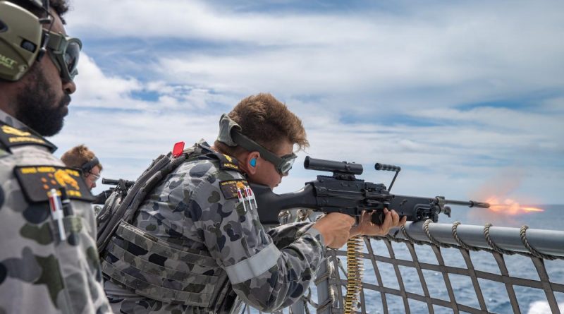 Leading Seaman Nathan Bob, left, directs Able Seaman Bradley Hocking as he fires an F89 Minimi on the flight deck of HMAS Arunta in the lead-up to the ship's regional presence deployment. Story and photo by Leading Seaman Sittichai Sakonpoonpol.