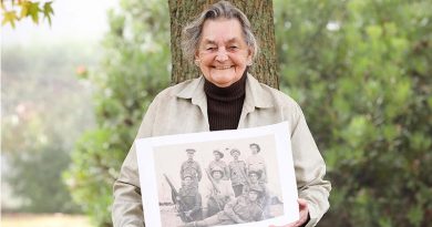 Private Edward Attfield’s great-niece, Beverley Warren, holds a photo featuring Private Attfield, who is believed to be the digger lying down. Photo by Able Seaman Bonny Gassner.