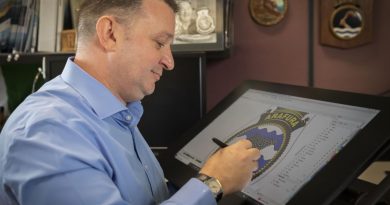 Manager Navy Badges, Paul 'Badger' Burnett, works on the NUSHIP Arafura badge in Canberra. Story and Photo by Leading Seaman Kylie Jagiello.