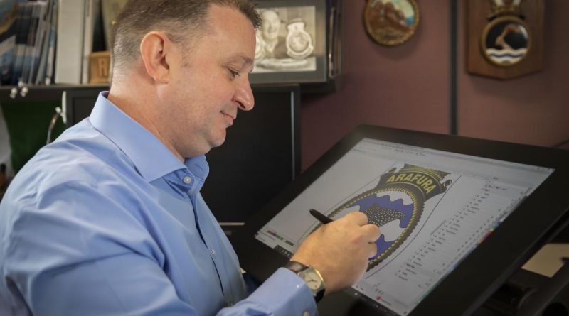 Manager Navy Badges, Paul 'Badger' Burnett, works on the NUSHIP Arafura badge in Canberra. Story and Photo by Leading Seaman Kylie Jagiello.