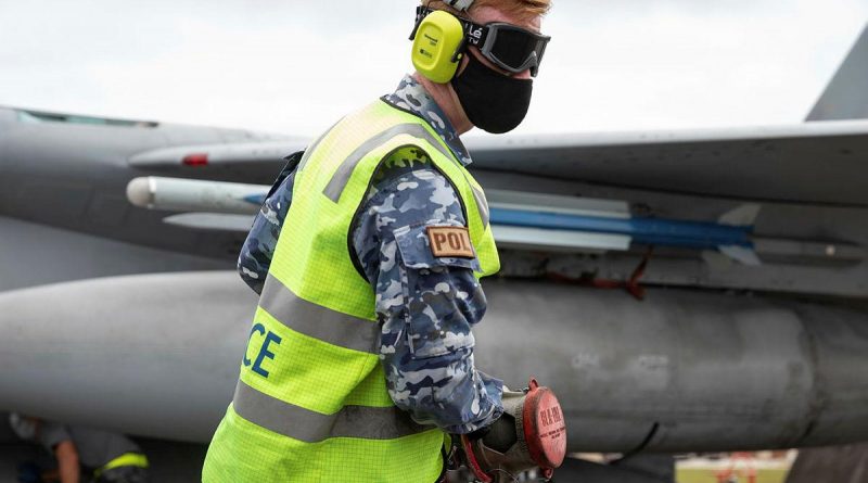 Leading Aircraftman Ronan Geoghgan, from No. 23 Squadron, retrieves a hose after refuelling a Japan Air Self-Defense Force F-15J Eagle aircraft at Andersen Air Force Base, Guam, during Exercise Cope North 2022. Story by Flying Officer Bronwyn Marchant. Photo by Leading Aircraftman Sam Price.