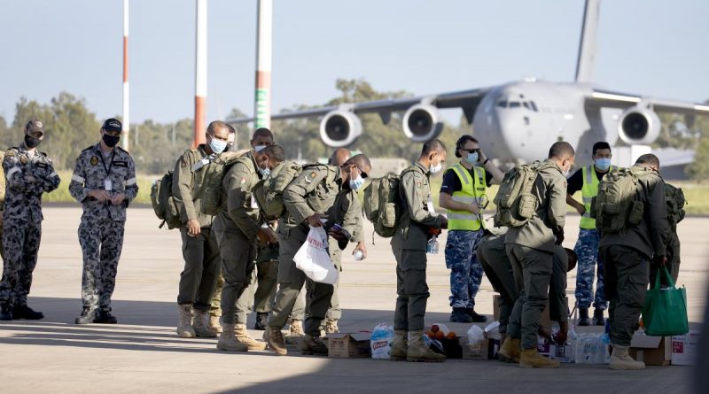 Royal Australian Air Force air movements personnel assist Republic of Fiji Military Forces engineers and medical personnel bound for Tonga to a C-130J Hercules aircraft at RAAF Base Amberley in Queensland. Story by Flying Officer Robert Hodgson. Photo by Leading Aircraftwoman Kate Czerny.