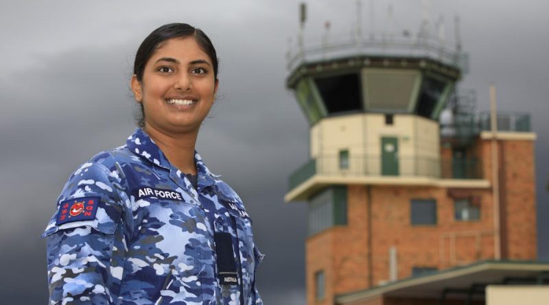 Royal Australian Air Force air traffic controller Pilot Officer Gulman Madahar, of No. 452 Squadron, in front of the RAAF Base Amberley air traffic control tower in Queensland. Story by Flight Lieutenant Jessica Aldred. Photo by Corporal Brett Sherriff.