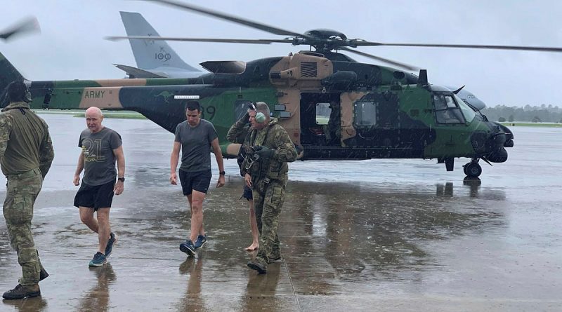 Soldiers from the School of Army Aviation arrive safely at RAAF Base Amberley on Friday, 25 February 2022, after rescuing several south-east Queensland community members affected by the rising flood waters.