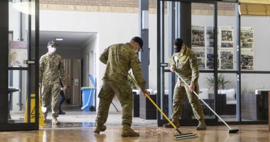 Soldiers from 5th Battalion, Royal Australian Regiment, assist with the clean-up at a nursing home in Brisbane. Story by Lieutenant Geoff Long. Photo by Leading Air Crewman John Solomon.