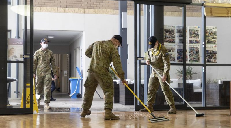 Soldiers from 5th Battalion, Royal Australian Regiment, assist with the clean-up at a nursing home in Brisbane. Story by Lieutenant Geoff Long. Photo by Leading Air Crewman John Solomon.