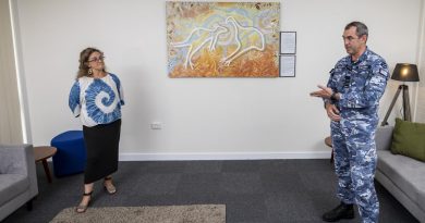 Group Captain James Badgery thanks artist Leanne Tobin, of the Buruberongal and Wumali clans of the Dharug, for her artwork that will hang in the Mirrung Room at the Air Lift Systems Program Office, RAAF Base Richmond. Story by Eamon Hamilton. Photo by Corporal Dan Pinhorn.