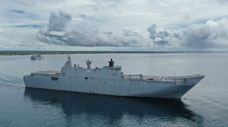 HMAS Canberra and HMAS Supply (left) sail into Nuku‘alofa harbour in Tonga as part of Operation Tonga Assist 2022. Photo by Petty Officer Christopher Szumlanski.