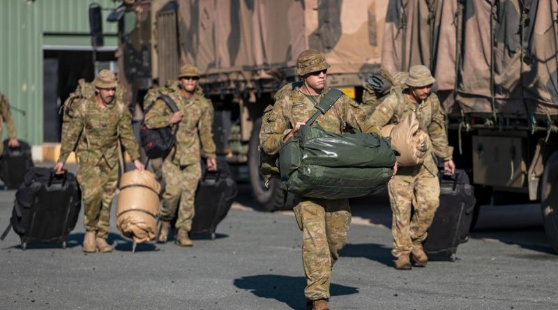 Army officer Lieutenant Thomas West, front, and other soldiers load gear onto trucks at Gallipoli Barracks in Brisbane in preparation to deploying to Gympie as part of Operation Flood Assist 2022. Story by Captain Taylor Lynch. Photo by Corporal Nicole Dorrett.
