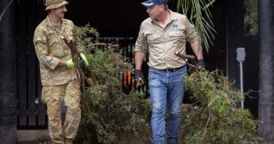 Private Rory Khochoba (left) from 6th Battalion, Royal Australian Regiment, working alongside the Lord Mayor of Brisbane, Adrian Schrinner, clearing debris from flood-damaged houses in Windsor, Brisbane. Story by Lieutenant Geoff Long. Photo by Corporal Jonathan Goedhart.