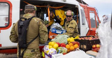 Sergeant Jody Cropp from 41st Battalion, Royal New South Wales Regiment loads crates of fresh food onto a helicopter operated by New South Wales Rural Fire Service, ready for delivery to areas of Northern NSW. Story by Major Jesse Robilliard. Photo by Corporal Dustin Anderson.