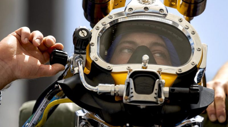 Royal Australian Navy sailor Able Seaman Clearance Diver Jake Phillips prepares to survey ferry terminal pylons along the Brisbane River as part of Operation Flood Assist 2022. Photo by Corporal Julia Whitwell.