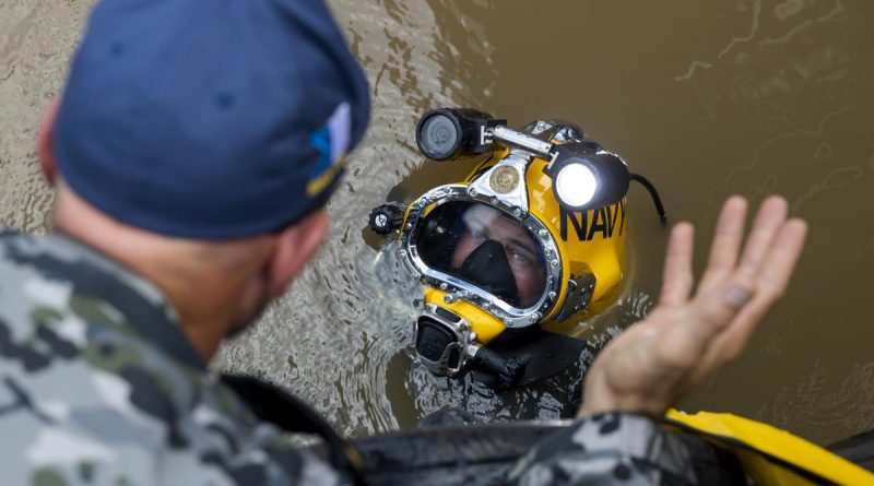 Royal Australian Navy clearance diver Able Seaman Jake Phillips prepares to survey ferry terminal pylons along the Brisbane River as part of Operation Flood Assist 2022. Story by Captain Simon Hampson. Photo by Corporal Julia Whitwell.