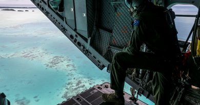 Loadmaster Corporal Jakeb Thorogood looks out over the C-17J Spartan aircraft ramp during a maritime surveillance flight over Palau’s Exclusive Economic Zone (EEZ). Photo by Leading Seaman Nadev Harel.