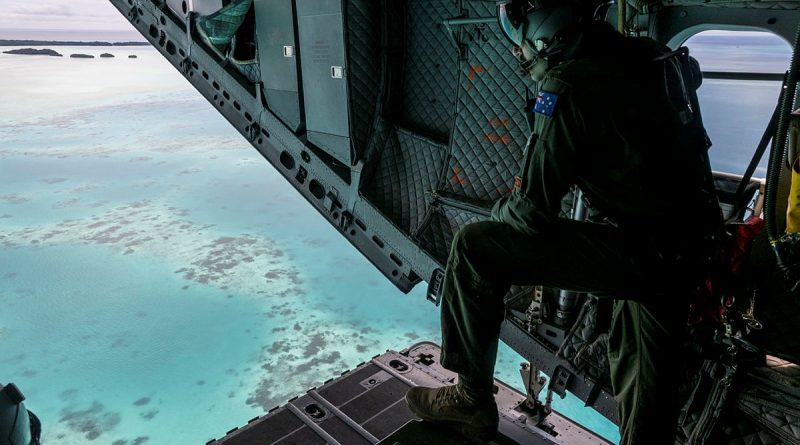Loadmaster Corporal Jakeb Thorogood looks out over the C-17J Spartan aircraft ramp during a maritime surveillance flight over Palau’s Exclusive Economic Zone (EEZ). Photo by Leading Seaman Nadev Harel.