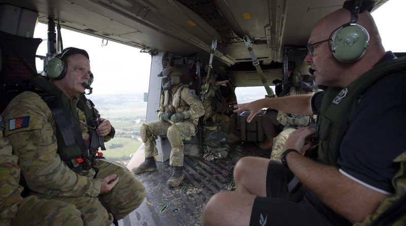Major-General David Thomae and Mayor of Lismore Steve Krieg survey the damage and recovery efforts in Lismore from an Army MRH-90 Taipan. Story and photo by Warrant Officer Class 2 Max Bree.