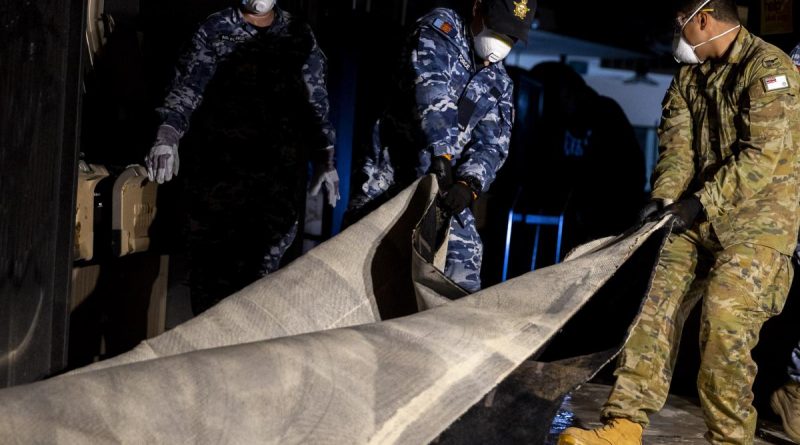 Air Force personnel remove flood-damaged carpet from Goodna Services Club, Brisbane, as part of Operation Flood Assist 2022. Story by Flight Lieutenant Tanya Carter. Photo: by Corporal Julia Whitwell.